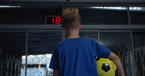 Little kid boy soccer player with ball going to empty stadium, dreaming of Stock Footage 139220053
