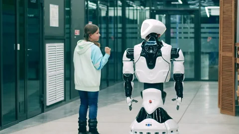 Little kid communicating with a cybernetic robot. Robotic science, technology Stock Footage