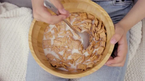 Little Kid Does Not Want To Eat Corn Flakes With Milk in Wooden Bowl Stock Footage 239067205