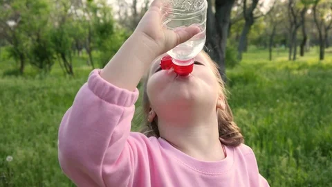 Little kid girl funny drinking a clean w. Stock Video Pond5