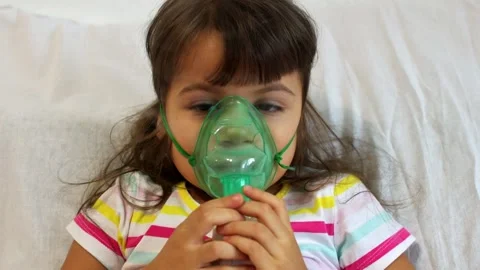 Little kid girl making inhalation with nebulizer at home. Stock Footage