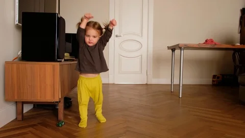 Little kid having fun while playing expressively at home Stock Footage 127114308
