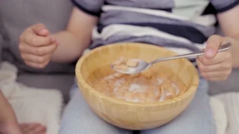 Little Kid Holding Spoon With Flakes And Milk In Front Of Camera, Moving Camera Stock Footage 239067167