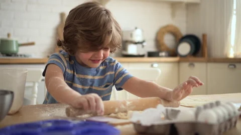 Little kid learns to cook boy rolls and plays with dough Video stock 161121639