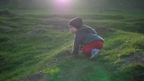 Little kid learns by himself how to rise and stand on his feet Stock Footage 305129540