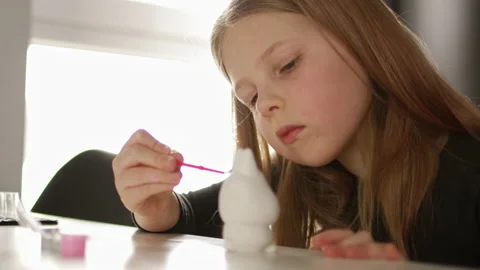 Little kid painting ceramic easter bunny figure. Child making DIY Stock Footage 189941267