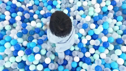 A little kid playing in the ball Stock Footage 262865670