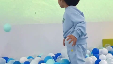A little kid playing in the ball pool, slow motion Stock Footage 262865716