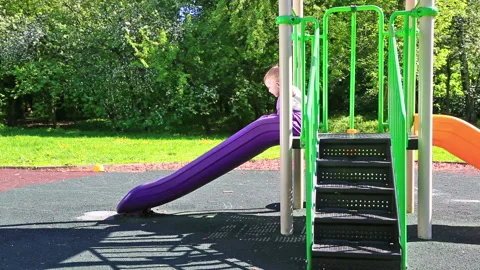 Little kid playing on a slide Video stock 96738469
