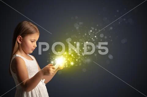 Little kid playing on sparkling tablet Stock Photos