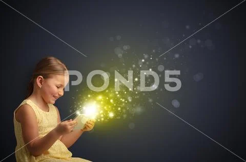 Little kid playing on sparkling tablet Stock Photos