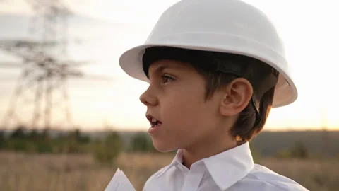 Little kid pretending engineer or manager with safety helmet, with papers Stock Footage 288722215