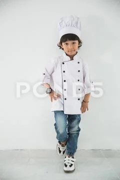 Little kid profession uniform pretending to be a chef Stock Photos