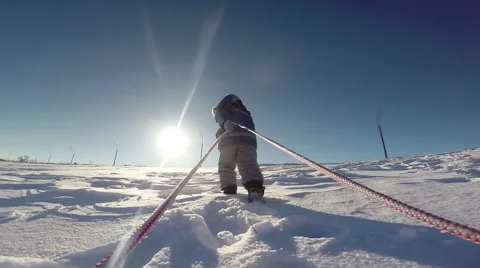 Little kid pulling sled to the slope top Stock Footage 42309761