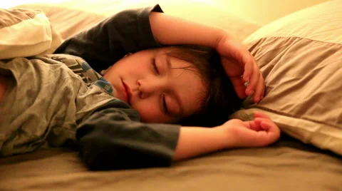 Little kid sleeping in his bedroom tucked in Stock Footage