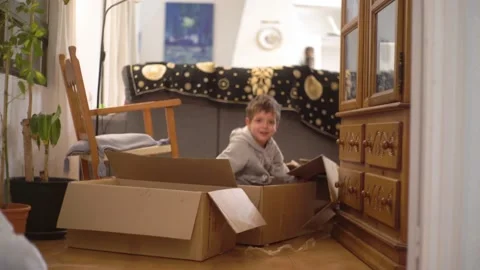 Little kids playing with moving boxes Stock Footage 201816978