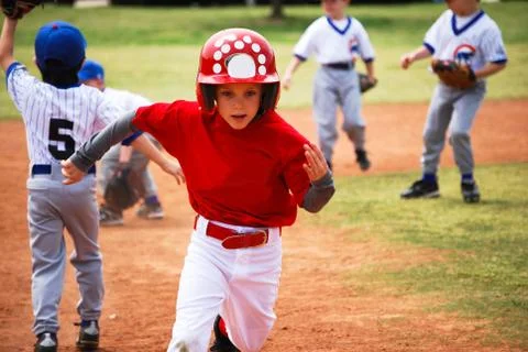 Little league baseball player running bases Stock Photos