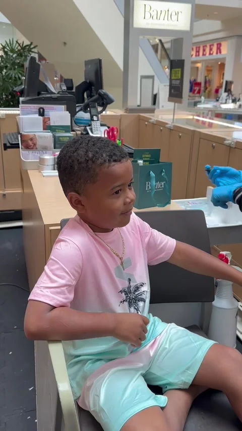Little Man Tries Not to Cry While Getting His Ears Pierced, Baltimore, Maryland, Stock Footage 341439977