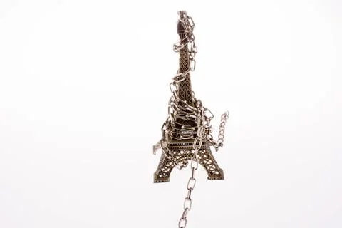 Little model Eiffel Tower in chains on a white background Stock Photos