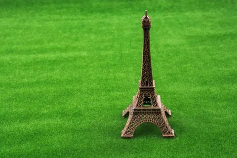 Little model Eiffel Tower  on grass 스톡 사진