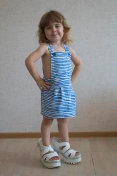 Little model posing in studio. Small model with long hair. She standing in her Stock Photos