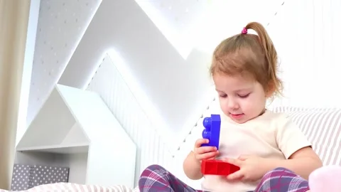 Little one engages in creative play with colorful building blocks indoors 스톡 동영상 295353207