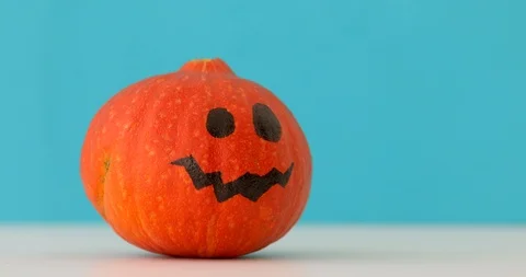 Little orange pumpkin dancing on blue background Stock Footage 116760941