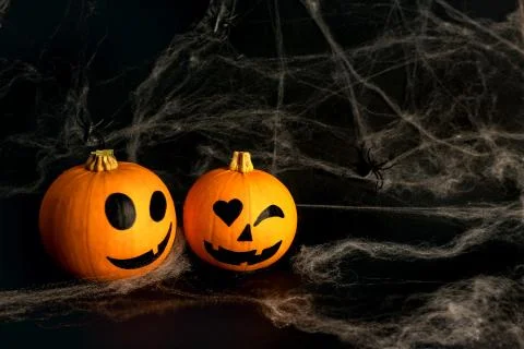 Little orange pumpkins with painted faces for Halloween Stock Photos