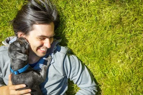 Little Pet Dog and His Owner Having Fun Outdoors Stock Photos