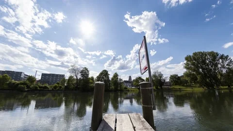 Little Pier at the River Limmat with Clouds, Trains, and the Sun Stock Footage 149373227