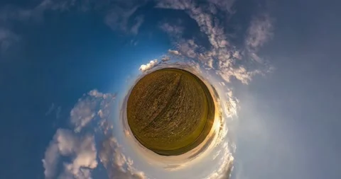 Little planet revolves among beautiful evening fluffy clouds. loop rotate Stock Footage 133648642