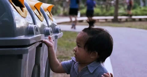 Little preschool boy keep garbage into bin Stock Footage 129910197