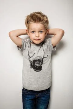 Little pretty boy posing at studio as a fashion model Stock Photos
