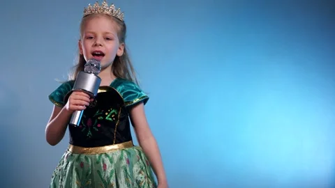 A little princess, voice soaring, a captivating performance. The Queen sings Stock Footage 304290803