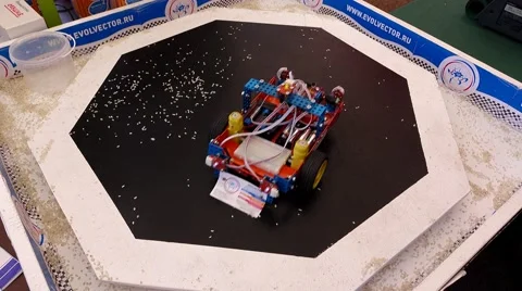 Little robot plow out garbage from area, self-operated cleaner prototype at fair Stock Footage 65485944