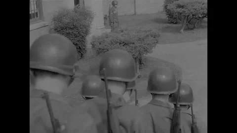 LITTLE ROCK - 1957: Desegregation — Troops cross high school terrace and path Stock Footage 342230924