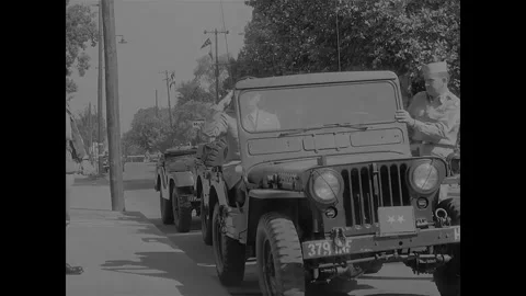 LITTLE ROCK - 1957: Desegregation — Two-star jeep heads roadside vehicle column Stock Footage 342230939