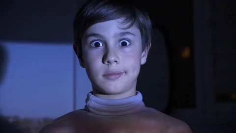 Little Scared Boy watching Horror Film or Video on TV or Computer in the Dark Stock Footage 97166172