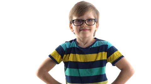 Little schoolboy poses in studio on a white background - raises his hand with a 스톡 동영상 124222584
