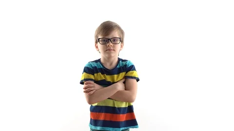 Little schoolboy poses in studio on a white background - raises his hand with a Vídeos de archivo 124578907