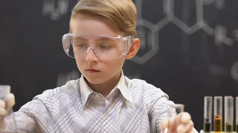 Little scientist comparing flasks with blue and red liquids, experiment result Stock Footage 110662749