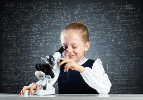 Little scientist looking through microscope Stock Photos