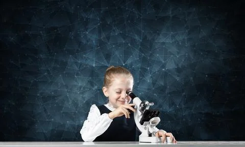 Little scientist looking through microscope Stock Photos