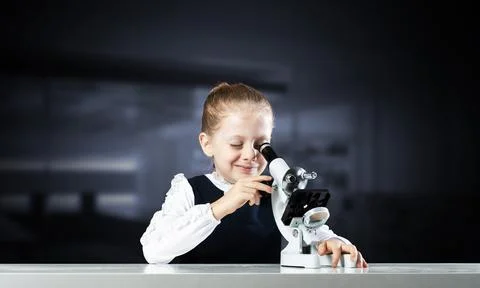 Little scientist looking through microscope Stock Photos