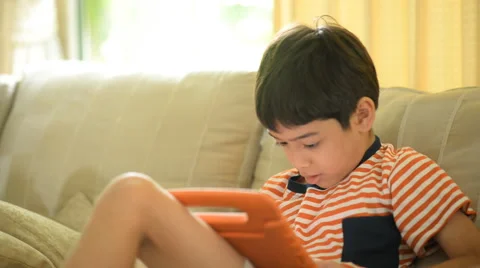 Little sibling boy playing game tablet mobile together Stockbeeldmateriaal 65035256