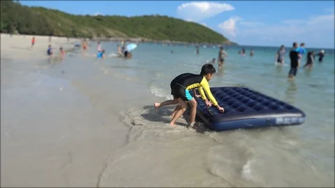 Little sibling boy playing sand on the beach summer time Stock-Footage 89754609