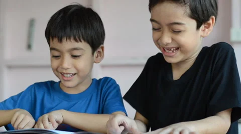 Little sibling boy reading book together with happy face Stockbeeldmateriaal 47702210