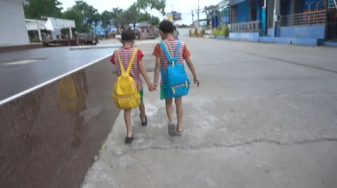 Little sibling boy walking on side walk going to school Stockbeeldmateriaal 65799832