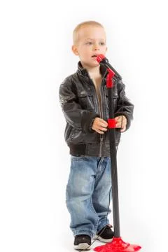 Little singer boy singing through a microphone Stock Photos
