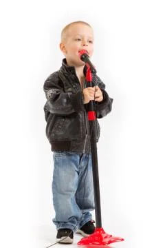 Little singer boy singing through a microphone Stock Photos